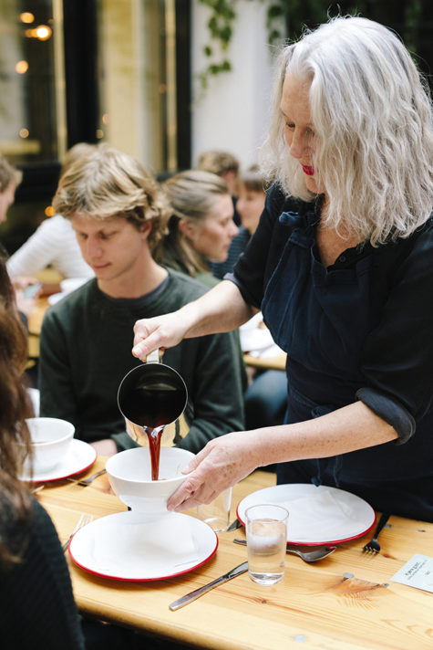 Kvinne serverer smaksprøve på suppe til mann.