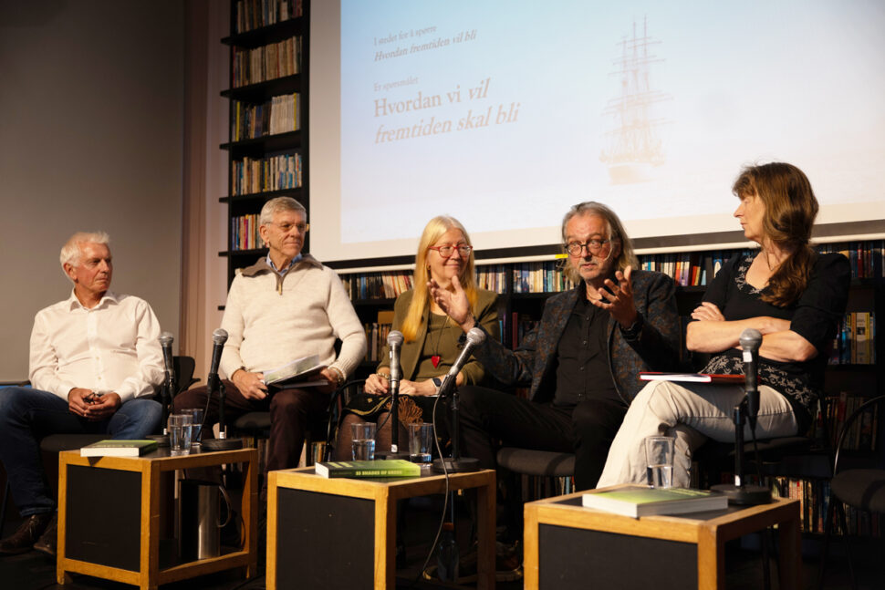 Mennesker på scene i paneldebatt